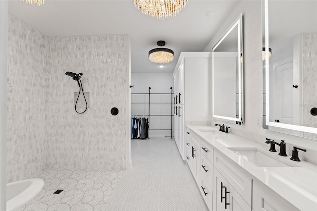 bathroom with vanity, tile patterned floors, and an inviting chandelier