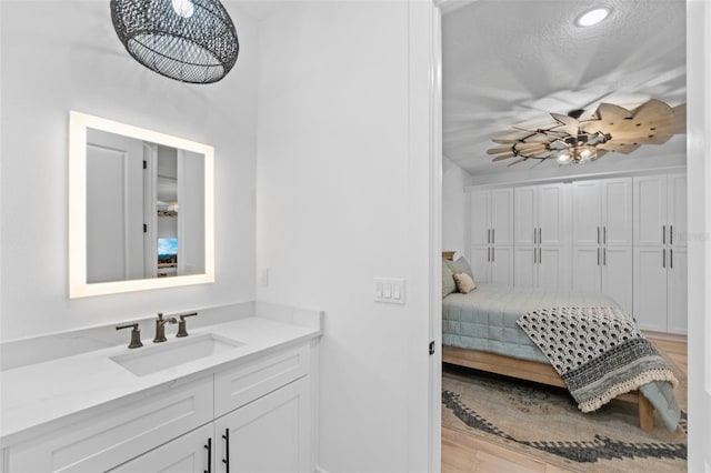 bedroom with sink and a textured ceiling