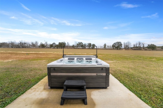 view of patio featuring a rural view and a hot tub