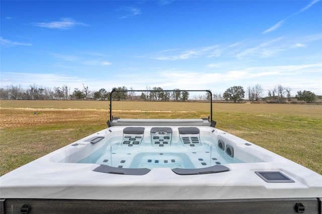 entry to storm shelter featuring a jacuzzi, a lawn, and a rural view