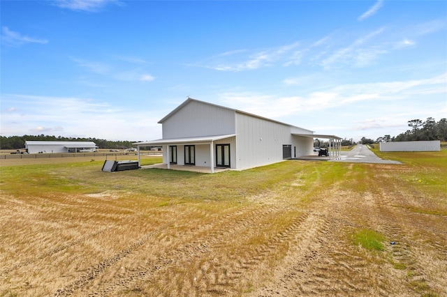 back of property featuring a yard and a patio area