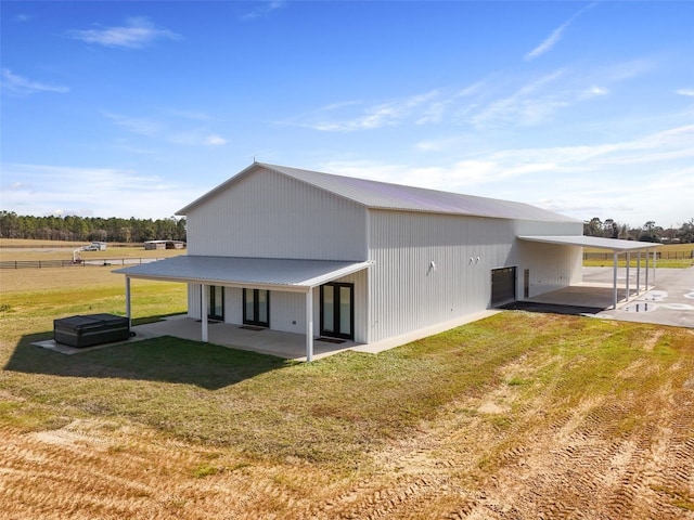 14771 SE 60th St, Morriston, FL 32668 - back of property with a patio area, a lawn, metal roof, and an attached carport