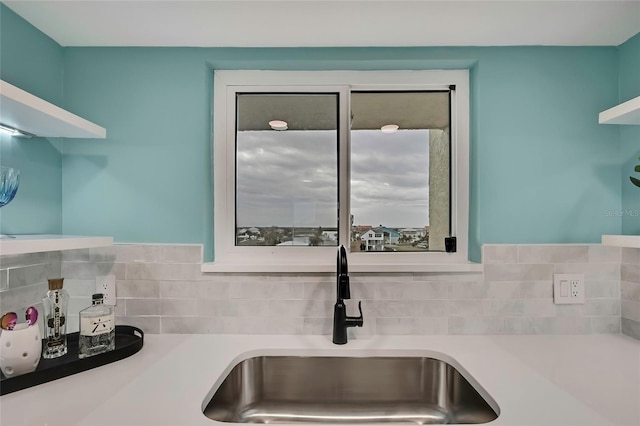 kitchen featuring tasteful backsplash and sink