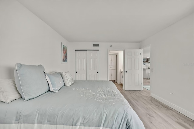 bedroom featuring light hardwood / wood-style flooring and a closet