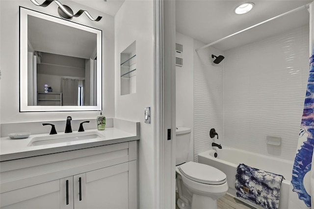 full bathroom featuring toilet, vanity, and shower / bathtub combination with curtain