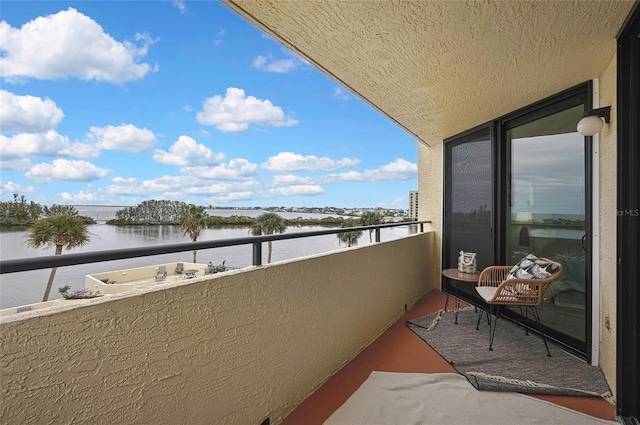 balcony featuring a water view