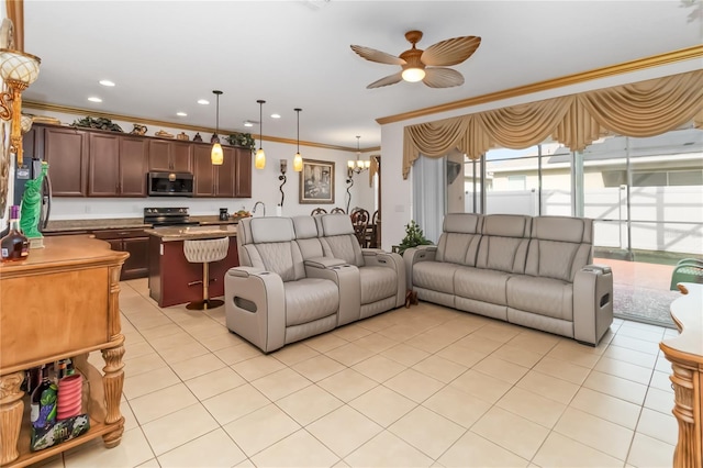 tiled living room featuring ornamental molding and ceiling fan with notable chandelier