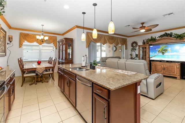 kitchen featuring sink, hanging light fixtures, an island with sink, and dishwasher