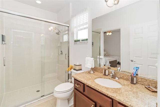 bathroom featuring a shower with door, vanity, and toilet