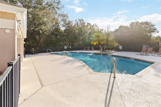 view of pool with a community hot tub and a patio area