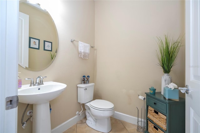 bathroom featuring sink, tile patterned floors, and toilet