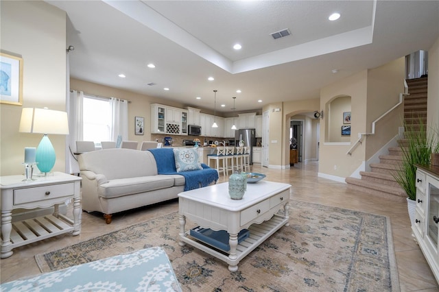 living room featuring a raised ceiling