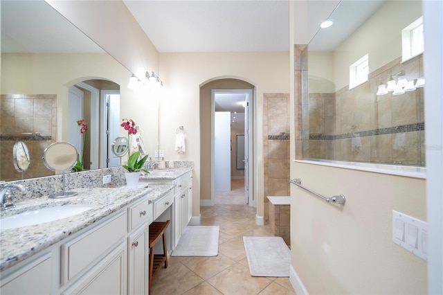 bathroom featuring vanity, tiled shower, and tile patterned floors