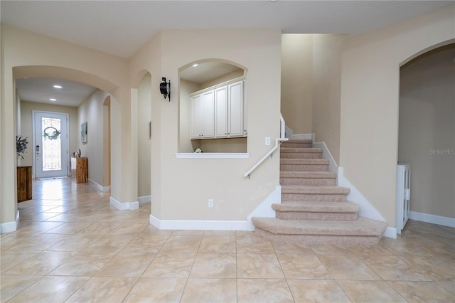 stairway with tile patterned floors