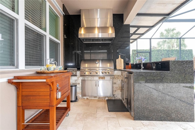 view of patio featuring an outdoor kitchen, a grill, sink, and glass enclosure