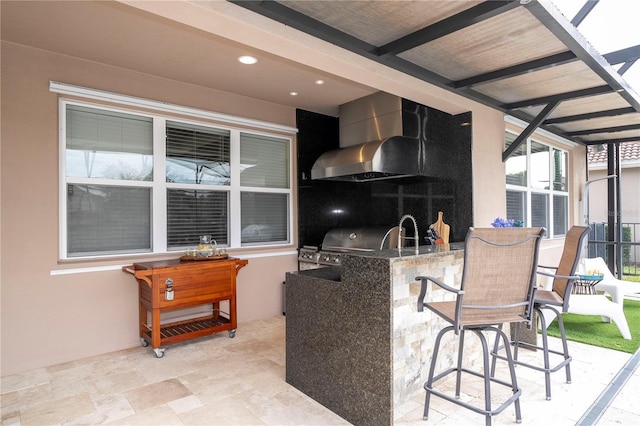 kitchen with sink and wall chimney exhaust hood