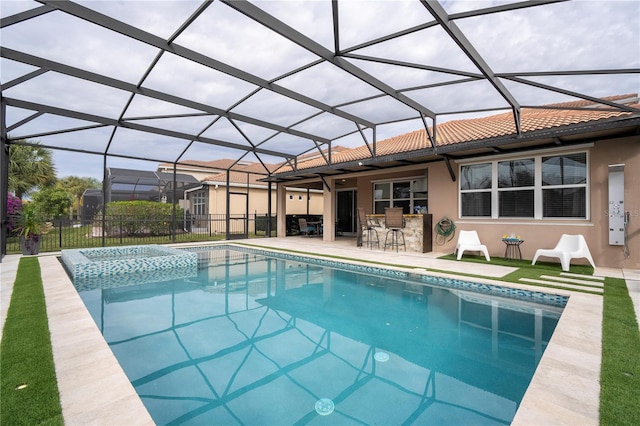 view of pool with a bar, a lanai, a patio area, and an in ground hot tub