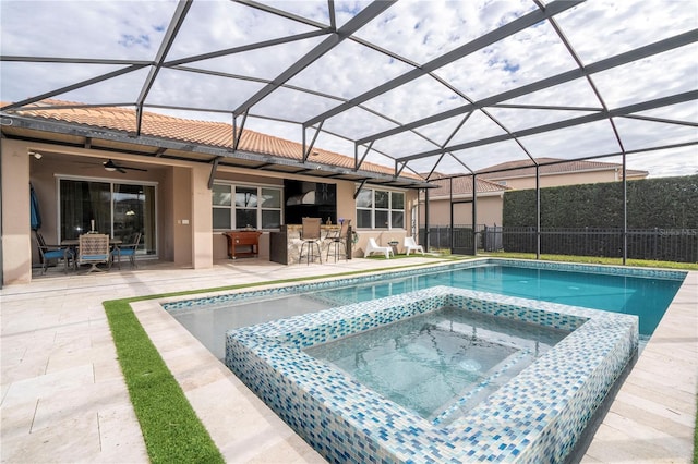 view of pool featuring exterior bar, an in ground hot tub, a lanai, ceiling fan, and a patio area