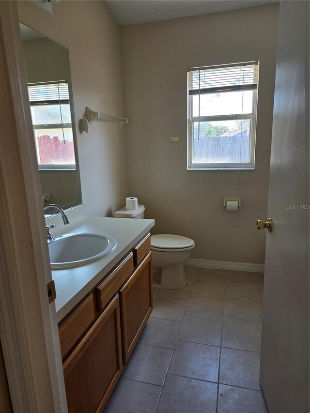 bathroom with tile patterned floors, toilet, and vanity