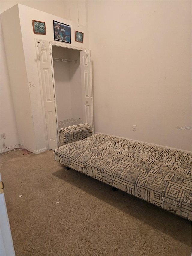 unfurnished bedroom with carpet floors and a closet