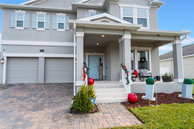 view of front of property with a garage and covered porch