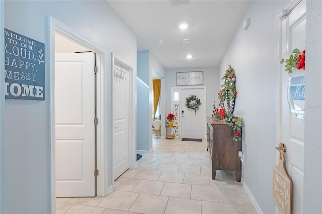 hall featuring light tile patterned flooring