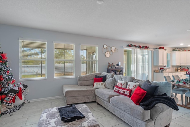 tiled living room with a textured ceiling