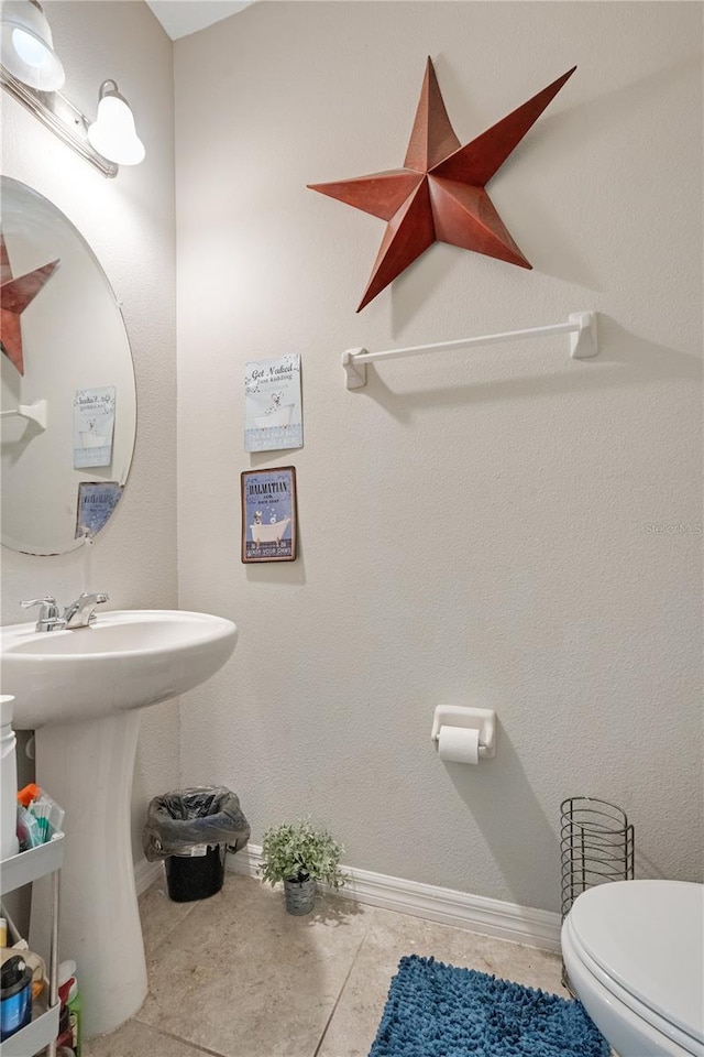 bathroom featuring sink, tile patterned floors, and toilet