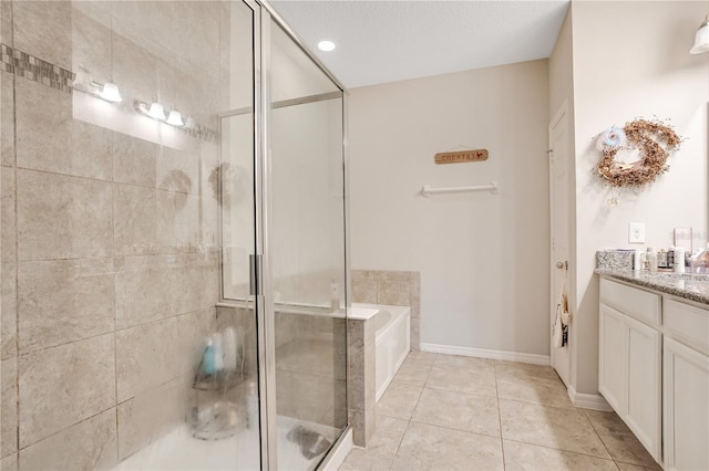 bathroom featuring tile patterned flooring, vanity, and plus walk in shower