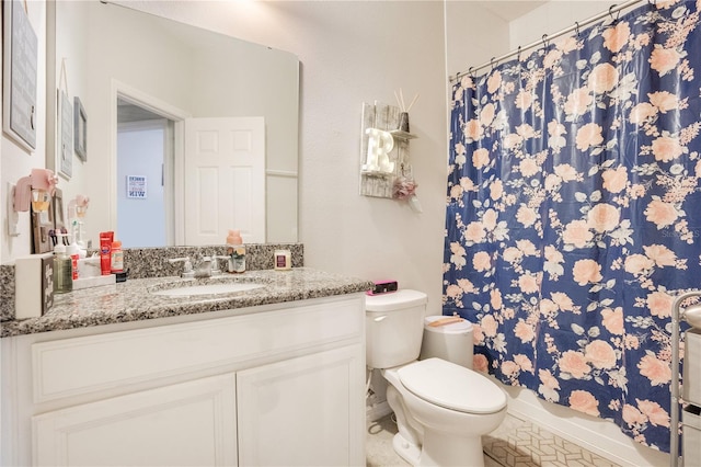 bathroom featuring tile patterned floors, vanity, and toilet