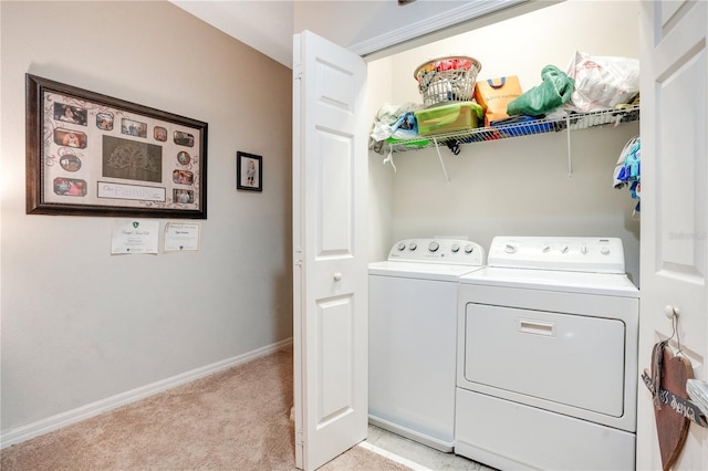 laundry room featuring light colored carpet and washing machine and clothes dryer