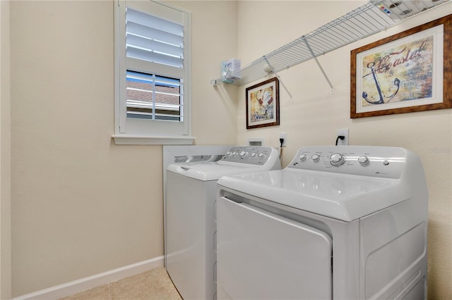 washroom with light tile patterned floors and washing machine and clothes dryer