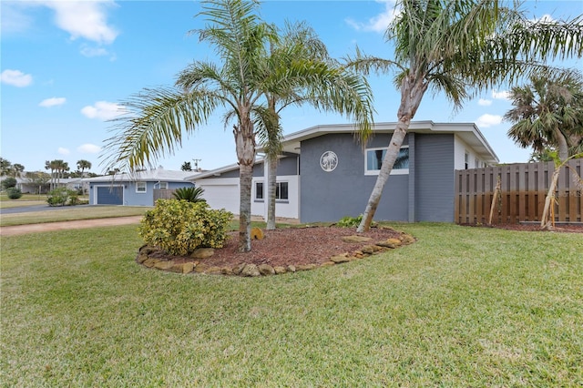 view of property exterior featuring a garage and a lawn