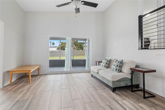 sitting room with ceiling fan and light wood-type flooring