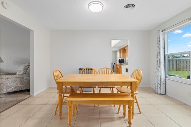 dining area with light tile patterned flooring