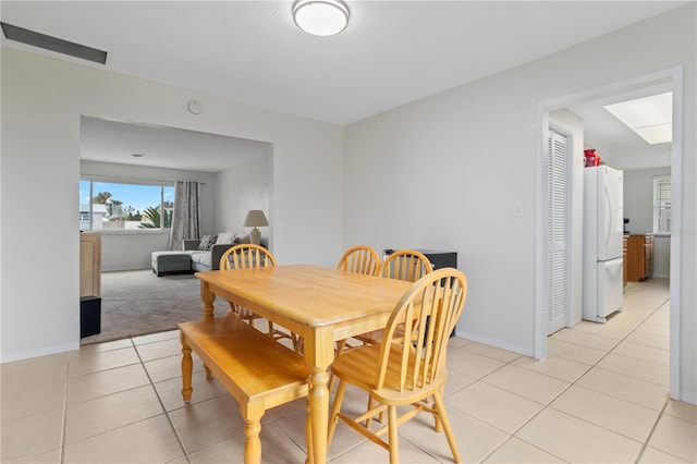 dining area with light tile patterned floors