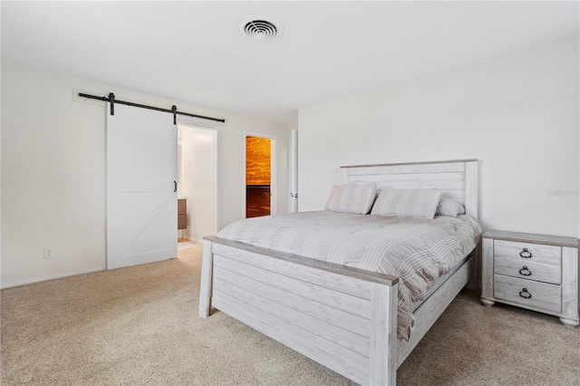 carpeted bedroom with a barn door