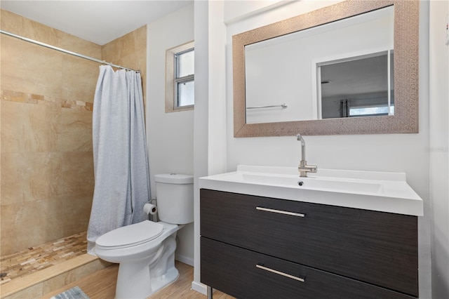 bathroom with walk in shower, vanity, toilet, and hardwood / wood-style flooring