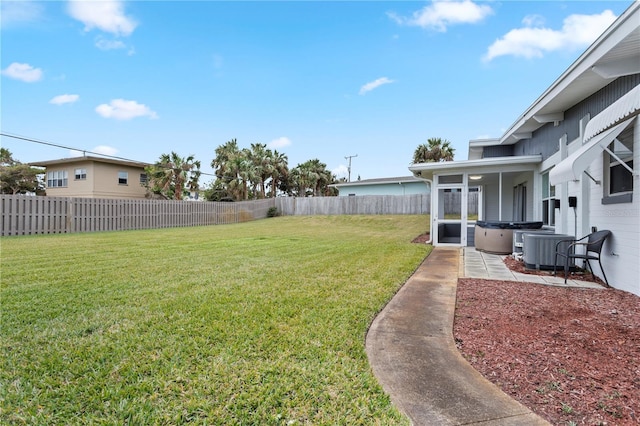 view of yard with a hot tub and central AC unit