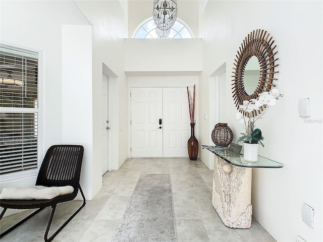 entrance foyer with a towering ceiling and a notable chandelier