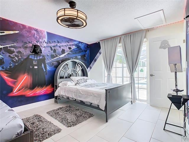 bedroom featuring a textured ceiling and light tile patterned floors