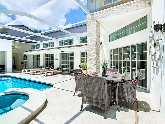 view of pool with a patio area and glass enclosure