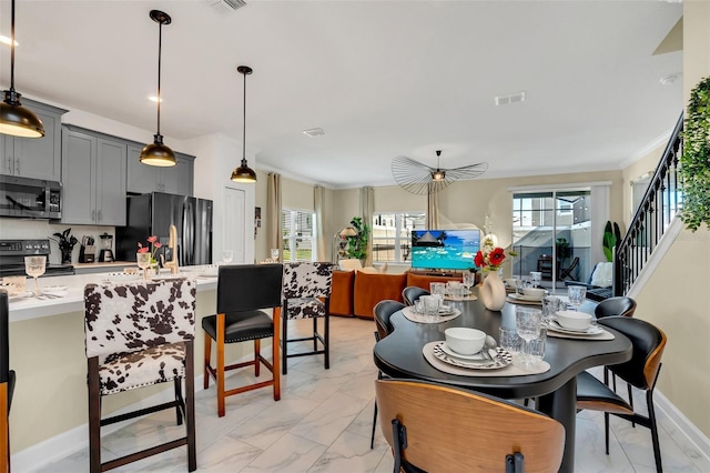 dining space with crown molding