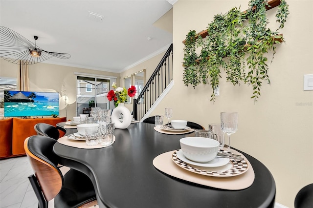 dining space with ornamental molding