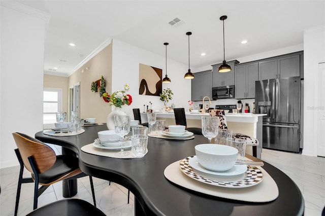 dining room featuring crown molding