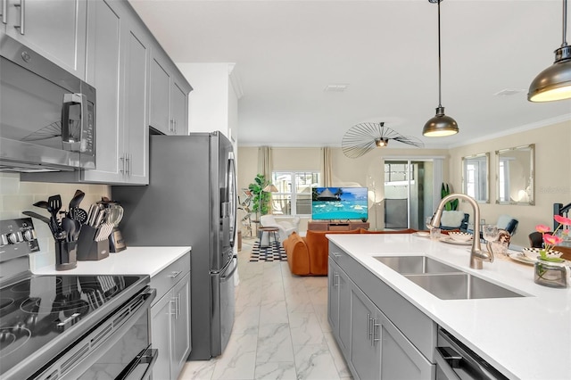 kitchen featuring sink, gray cabinetry, crown molding, hanging light fixtures, and black appliances