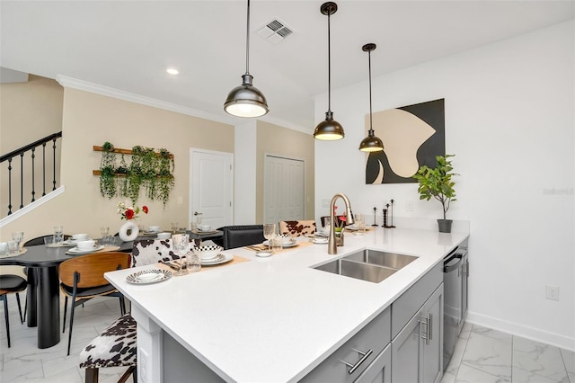 kitchen featuring dishwasher, sink, gray cabinetry, a kitchen breakfast bar, and kitchen peninsula