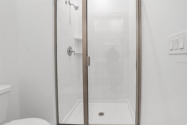 bathroom with toilet and walk in shower