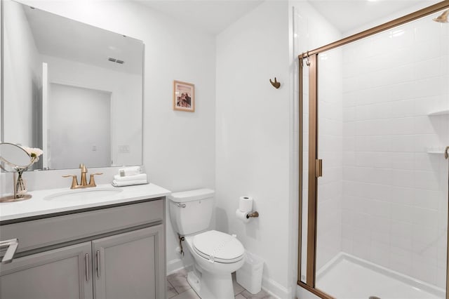 bathroom with vanity, toilet, and an enclosed shower