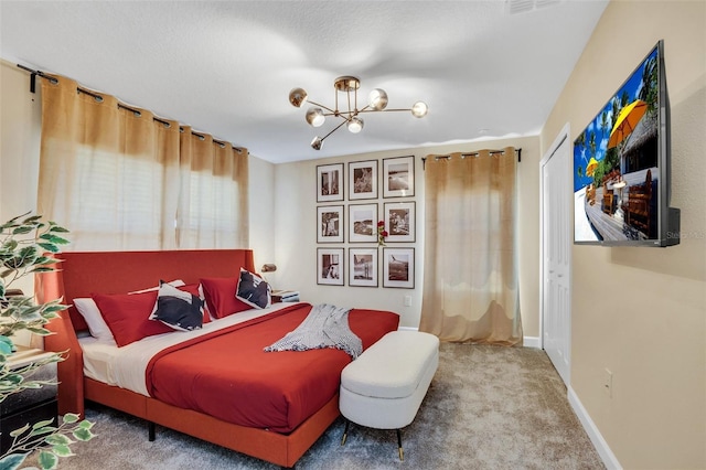 carpeted bedroom with a notable chandelier